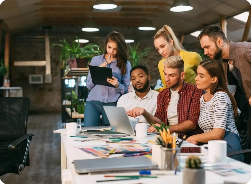 agency coworkers discussing new project on laptop